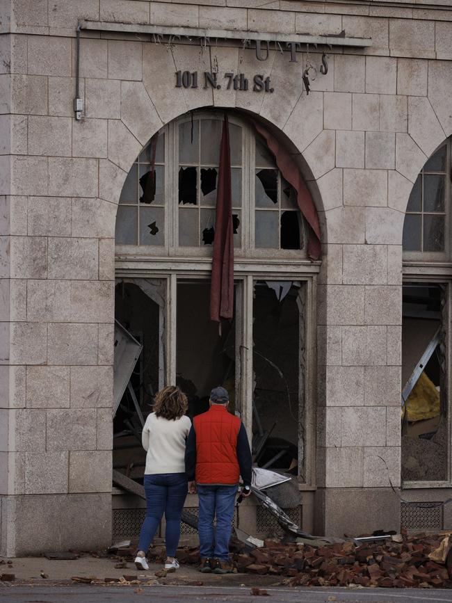 People survey a tornado damaged business in Mayfield, Kentucky. Picture: AFP