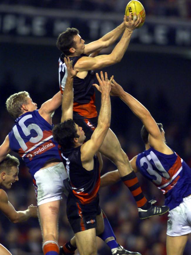 Justin Blumfield rises above a pack to mark for Essendon.