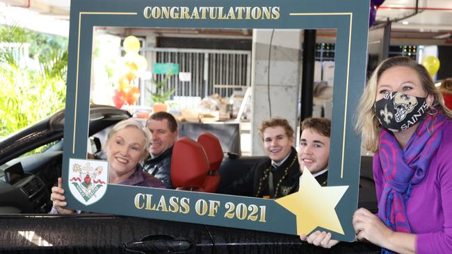 Year 12 teachers at St Augustine's College, Brookvale, had to farewell Year 12 students in the HSC Class of 2021 at a special graduation drive-through breakfast due to Covid restrictions. Students collected a breakfast pack from the teachers to share with their family at home while Zooming in to their graduation ceremony. Students Daniel Cook and Rohan Cook with their parents, and teacher Kathryn Bignold (left). Picture: St Augustine's College, Brookvale