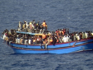 Italian authorities arrest five alleged human traffickers over the deaths of dozens of migrants.