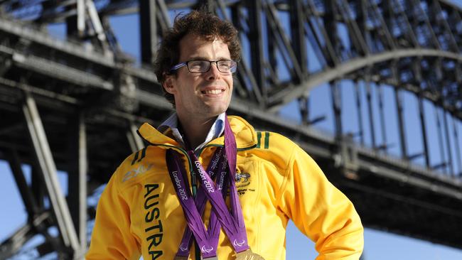 Visually impaired Paralympian, Matt Levy swam his way into 5 medals in the London Games. He is pictured with a bronze, silver and gold. He said he couldn't fit the other 2 in his backpack. Picture: Dave Swift