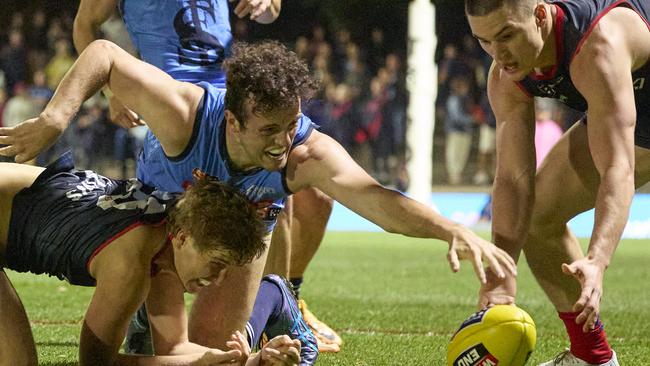 Sturt’s Lachlan Burrows (middle) fights for the ball against Norwood’s Jack Heard (left) and Matthew Ling in the Double Blues’ impressive victory at The Parade. Picture: Matt Loxton