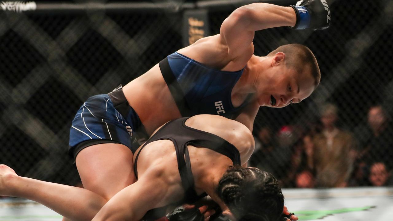 JACKSONVILLE, FL - APRIL 24: Rose Namajunas of the United States punches Zhang Weili of China during the Women's Strawweight Title bout of UFC 261 at VyStar Veterans Memorial Arena on April 24, 2021 in Jacksonville, Florida. (Photo by Alex Menendez/Getty Images)