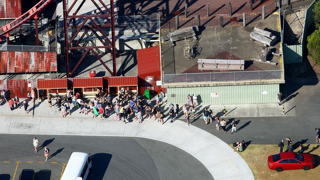 Crowds leave Dreamworld following the tragedy. Photo: David Clark