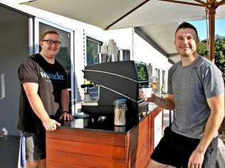 COOL CART: Wander Coffee Cart founder Ryan Ferguson at his morning pitch at the Goonellabah Business Hub with happy customer and landord David Russell. Picture: Alison Paterson