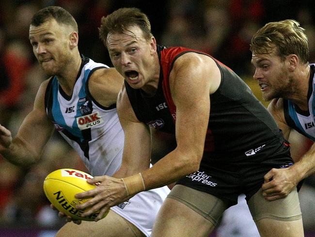 Brendon Goddard of the Bombers under pressure from Jack Watts of the Power during the Round 4 AFL match between the Essendon Bombers and the Port Adelaide Power at Etihad Stadium in Melbourne, Sunday, April 15, 2018. (AAP Image/Hamish Blair) NO ARCHIVING, EDITORIAL USE ONLY