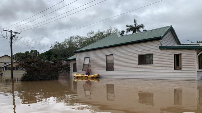 A rescue volunteer checks a home on Ewing Street on March 1, 2022, a day after Lismore was hit by a record flood. Picture: Stuart Cumming