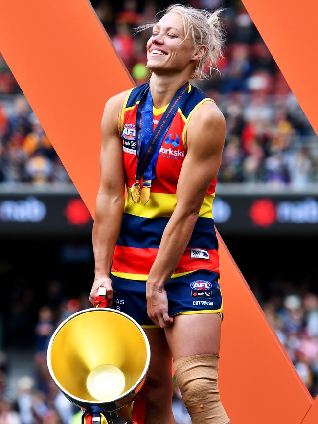 Phillips with the premiership cup and her heavily strapped. Picture: Getty Images