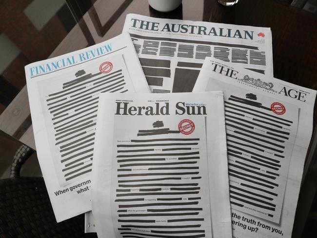 A selection of Nine and News Corp newspapers display a campaign called "Australia's Right To Know", Melbourne, Monday, October 21, 2019. The front pages of the major newspapers on Monday replicated a heavily redacted government document, alongside an advertising campaign challenging laws that effectively criminalise journalism and whistleblowing. (AAP Image/David Crosling) NO ARCHIVING