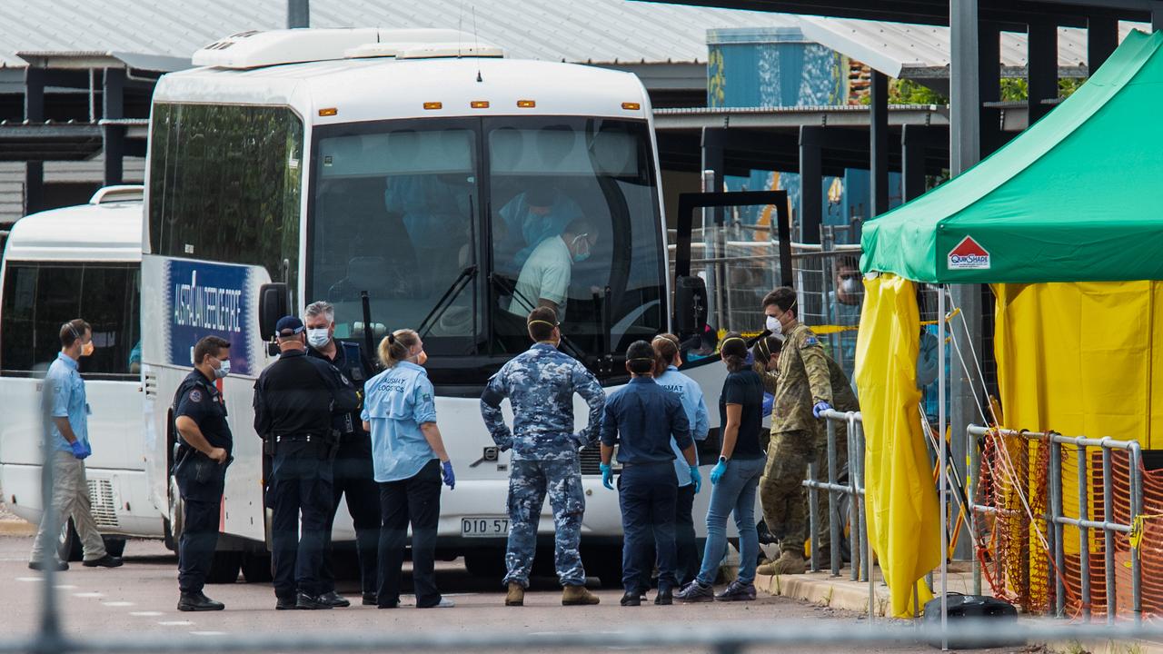 Government agencies gather near buses taking cruise ship passengers to the Howard Springs quarantine facility. Picture: AAP/Helen Orr