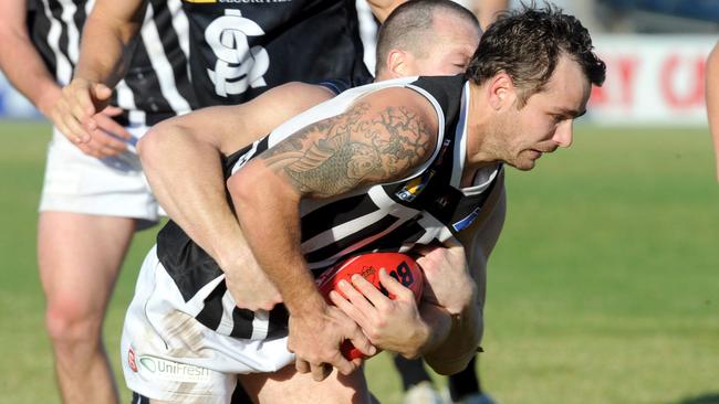 Port's Jeremy Clayton tackled in the forward pocket in an SANFL match against South Adelaide. Picture: Greg Higgs