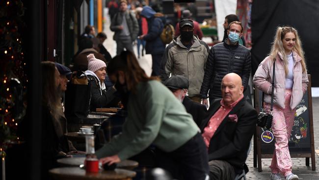 Customers enjoy drinks outside a restaurant in in London on December 2. Picture: AFP