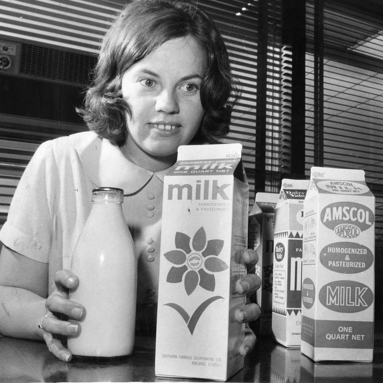 A worker for the Metropolitan Milk Board compared a pint bottle of milk with the quart cartons when they were introduced in 1969.