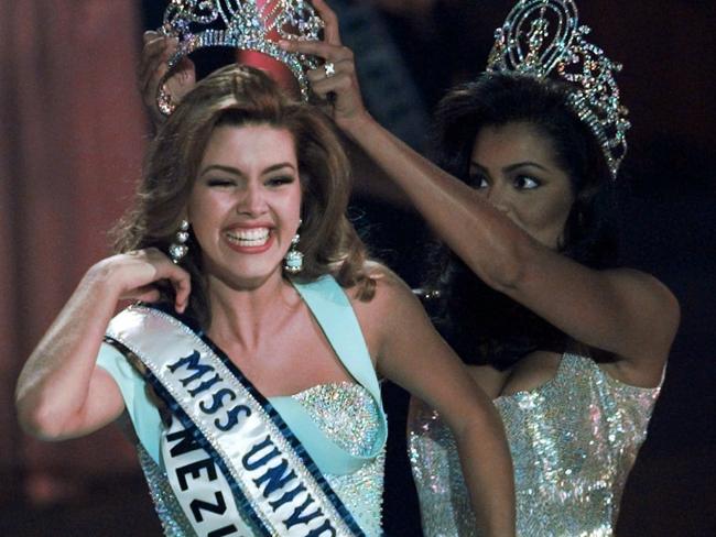 In this May 17, 1996, file photo, the new Miss Universe Alicia Machado of Venezuela reacts as she is crowned by the 1995 winner Chelsi Smith at the Miss Universe competition in Las Vegas. Picture: AP