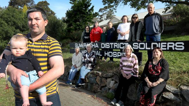 Joel Taggart and daughter Shiloh, 1, with other locals who are calling on the ED to reopen. Picture Dean Martin