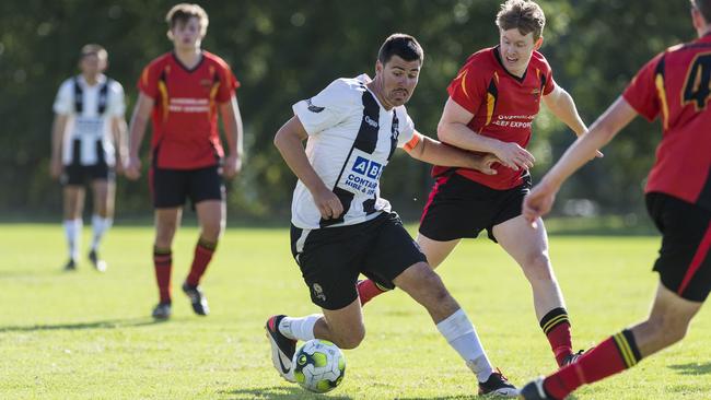 Willowburn captain Beau Partridge (left) takes on the Gatton defence.