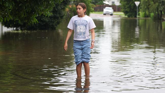 Annabella Giorgas 11 walks along her street in Hermit Park as Townsville residents endure another day of heavy rain and threats of catastrophic flooding. Picture: Adam Head /NewsWire