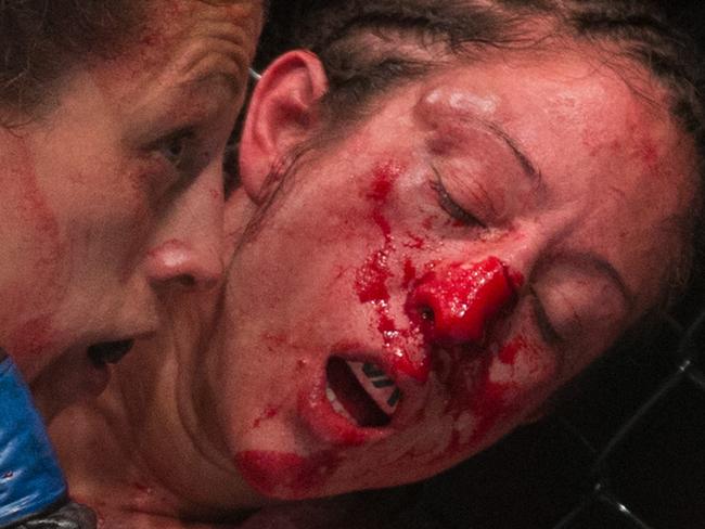 Joanna Jedrzejczyk, left, battles with Jessica Pennei for the women's strawweight title fight during UFC Fight Night in Berlin, Germany, Saturday, June 20, 2015. Jedrzejczyk defeated Pennei through KO/TKO.(AP Photo/Axel Schmidt)