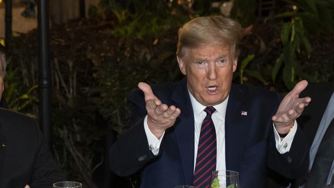 Donald Trump at a dinner with National Security Adviser Robert O'Brien. Picture: AP.