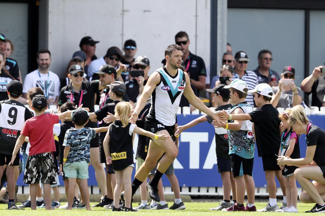 Power’s Travis Boak runs through a guard of honor as he runs onto the ground against North Melbourne at Alberton Oval. Picture SARAH REED