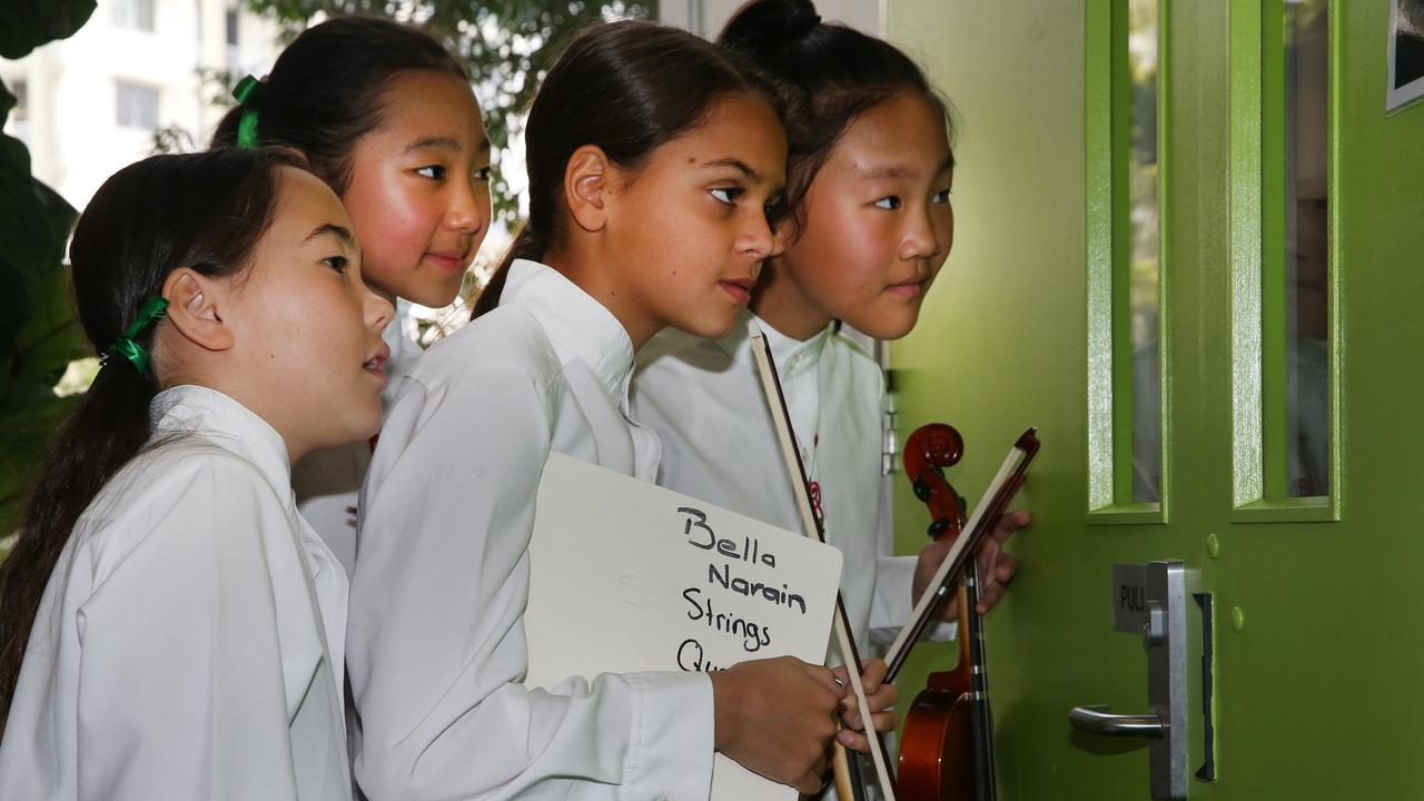 The Benowa State Primary school quartet keep an eye on the opposition while waiting their turn. Picture: Glenn Hampson.