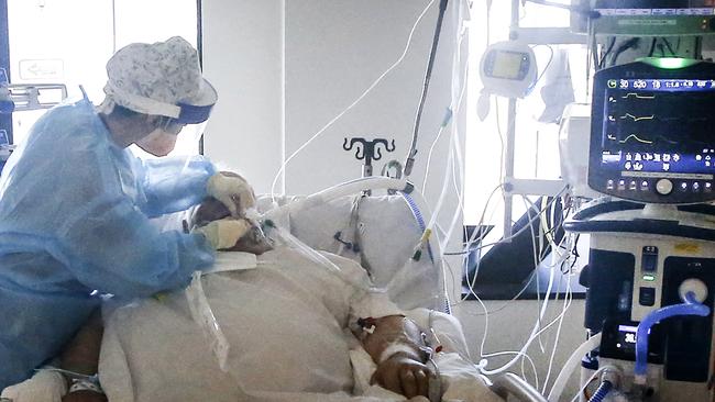 Behind the Scenes at the Royal Melbourne Hospital ICU. ICU nurse Chelsea Wong caring for a COVID patient in the ICU COVID ward.   Picture: David Caird