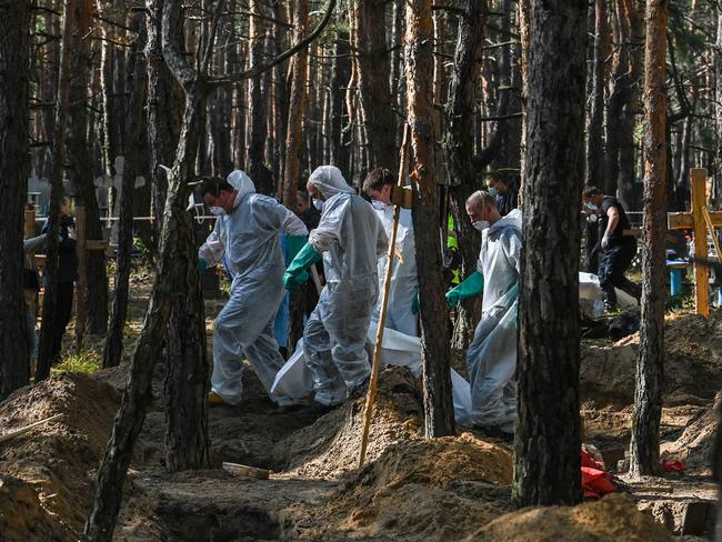 Ukrainian authorities discovered around 450 graves outside the formerly Russian-occupied city of Izyum with some of the exhumed bodies showing signs of torture. Picture: AFP