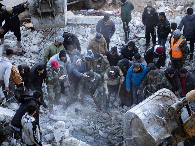 Residents search for victims and survivors amid the rubble of a collapsed building in the regime-controlled town of Jableh in the province of Latakia, northwest of the capital Damascus. Picture: AFP