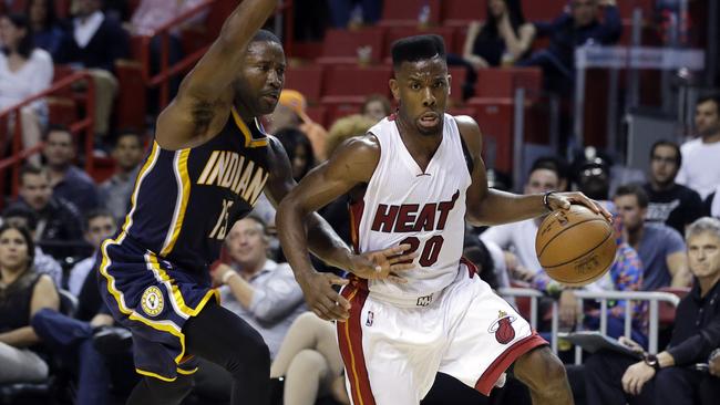 Miami Heat's Norris Cole (30) drives to the basket against Indiana Pacers' Donald Sloan (15).