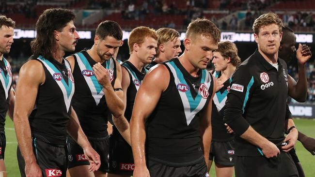 Port Adelaide players, including skipper Tom Jonas, walk off Adelaide Oval on Saturday night. Picture: Sarah Reed/AFL Photos