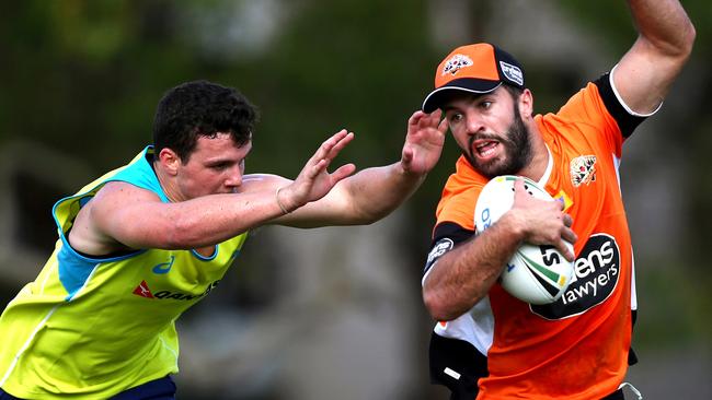 Wests Tigers James Tedesco evades a defender during a opposed session with the Aussie men's Seven's team. Picture: Gregg Porteous