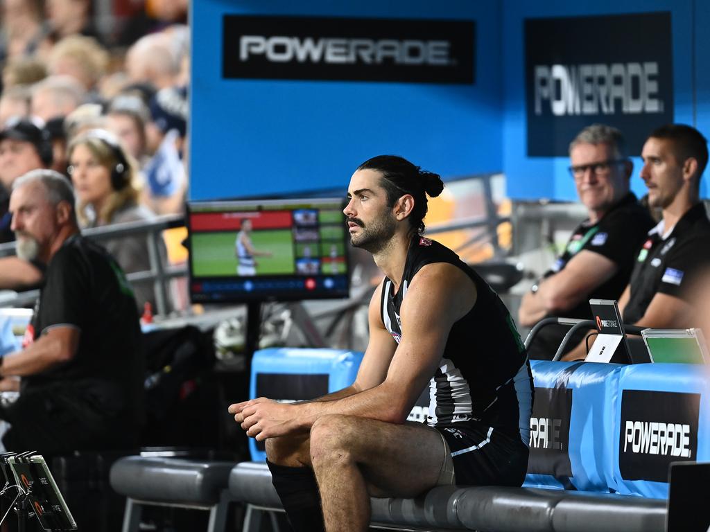 Brodie Grundy sits on the bench during the Magpies’ loss to the Cats.