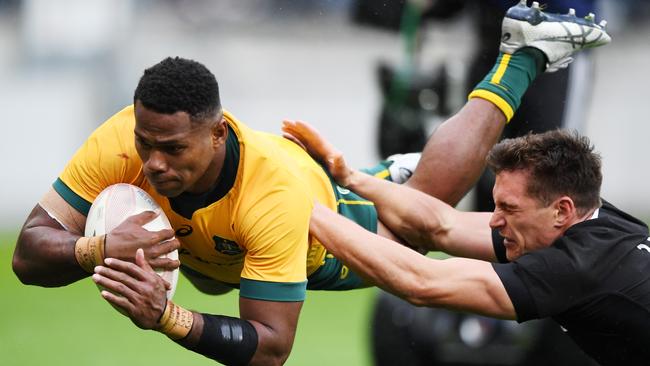 Wallabies winger Filipo Daugunu dives over to score a try against New Zealand at Sky Stadium in Wellington