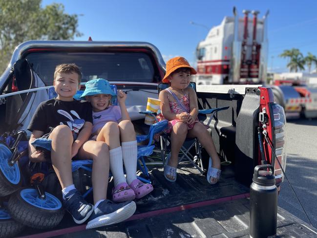 Samuel Kyle, 8, Alliana Booth, 7, and Chloe Kyle, 4, wait in the back of a utility vehicle to watch the convoy go past in Ingham Road.