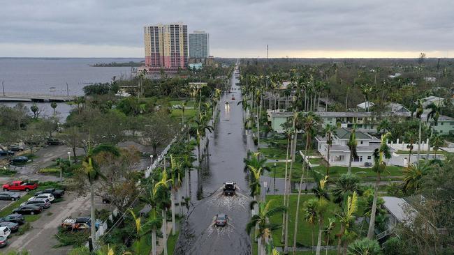 In this aerial view, vehicles make their way through a flooded area after Hurricane Ian passed through the area. Picture: AFP.