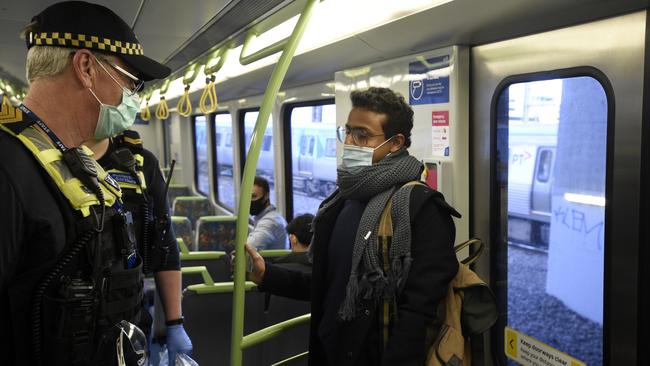 Police and PSOs enforcing mask-wearing on public transport. Picture: Andrew Henshaw