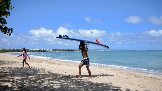 A surfer at a near-deserted Kuta beach on the Indonesian resort island of Bali. Picture: AFP