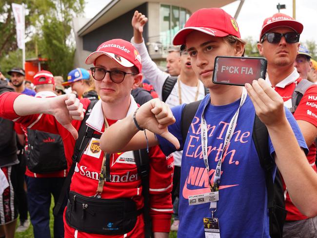 Spectators react after it was announced that the Formula 1 Australian Grand Prix 2020 was cancelled. Picture: AAP