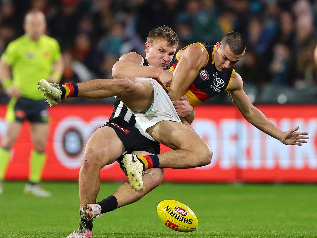 Ollie Wines tackles Josh Rachele during Showdown 56. Picture: Sarah Reed/AFL Photos