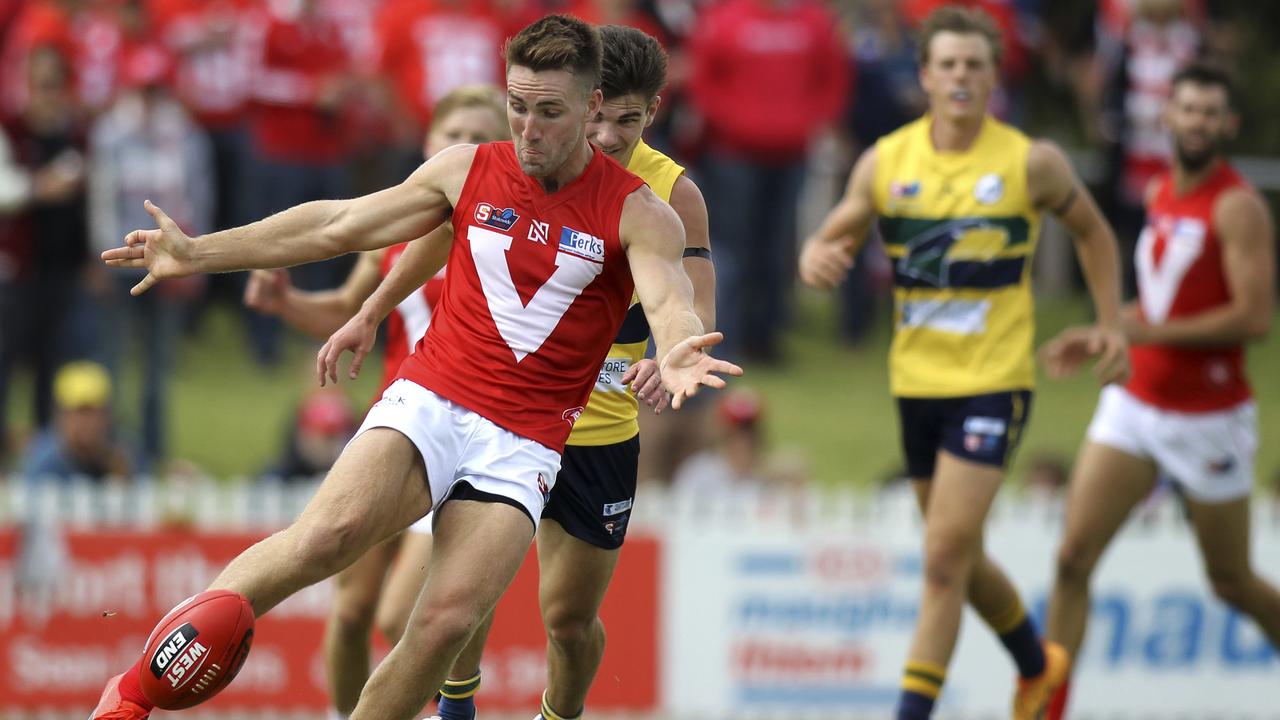 SANFL: Eagles v North Adelaide at Woodville Oval. North's Brock Castree clears the ball pursued by Eagle's Jake Johansen. 31 March 2019. (AAP Image/Dean Martin)