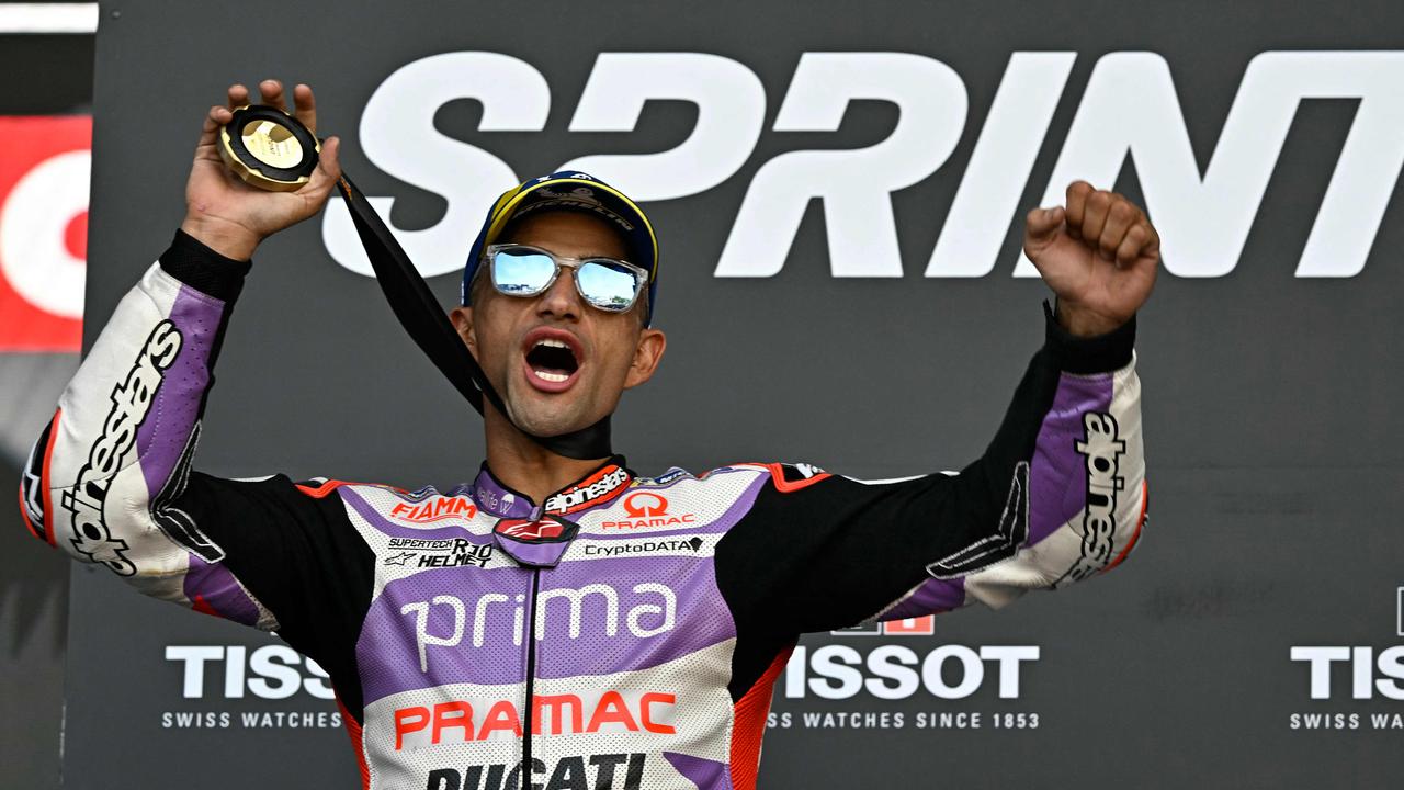 Ducati Spanish rider Jorge Martin celebrates on the podium after winning the sprint race of the MotoGP Valencia Grand Prix at the Ricardo Tormo racetrack in Cheste, on November 25, 2023. (Photo by JAVIER SORIANO / AFP)