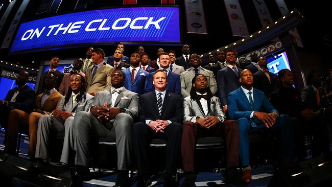 NFL Commissioner Roger Goodell sits with draft prospects.
