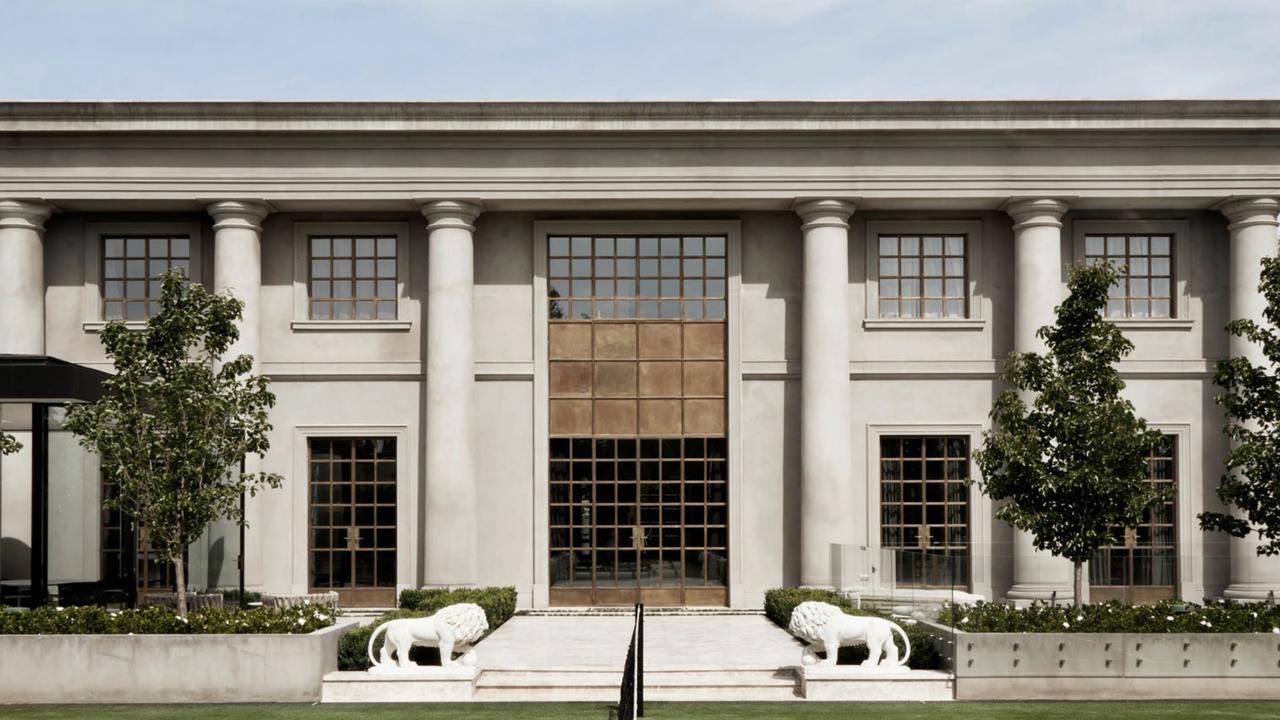 The neoclassical-style mansion in Toorak is guarded by two lion sculptures.