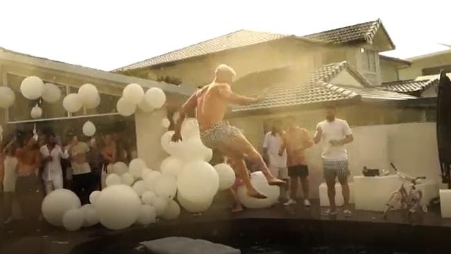 Gold Coast ex Motocross racer and freestyle rider Grant Bink in a daredevil leap off a house into swimming pool at New Year's Eve.