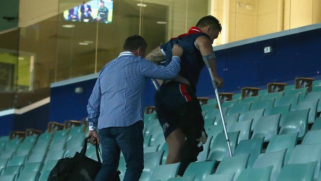 Waerea-Hargreaves walks up the stadium steps of the stadium on crutches.