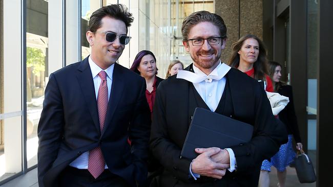 Journalist Joe Aston leaving Federal Court with his lawyer Sandy Dawson in December.