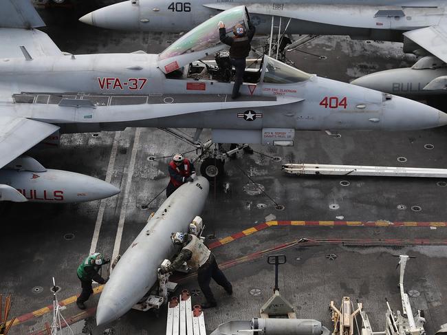 Flight deck crew prepare, clean and arrange aircraft during joint military exercise, Saxon Warrior, aboard the USS George H.W. Bush on August 6, 2017 off the north west coast of the United Kingdom. The American Aircraft carrier the USS George HW Bush is a nuclear powered 97,000-tonne, 20 story high Nimitz class aircraft carrier. It has a 4.5-acre flight deck with around 80 combat aircraft and is home to around 5,000 US Navy personnel who are currently conducting joint military exercises off the coast of the United Kingdom. Picture: Dan Kitwood/Getty Images