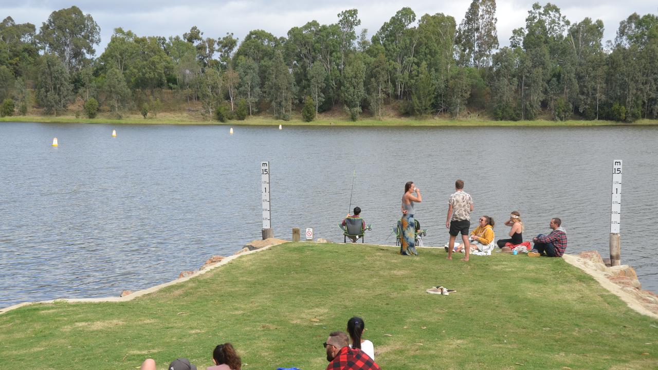 Patrons relax by the Claude Wharton Weir.