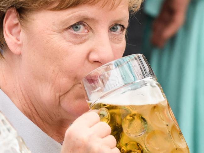 MUNICH, GERMANY - MAY 28: German Chancellor and Chairwoman of the German Christian Democrats (CDU) Angela Merkel drinks from a beer mug at the Trudering fest on May 28, 2017 in Munich, Germany. The CDU and CSU, along with the German Social Democrats (SPD), form the current German coalition government, though relations between Merkel and Seehofer have been complicated as the two have clashed over certain issues, especially immigration.  (Photo by Sebastian Widmann/Getty Images)