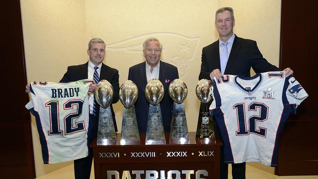 In this photo released by the Federal Bureau of Investigation, Harold H. Shaw, left, Special Agent in Charge of the FBI Boston Division and Colonel Richard D. McKeon, right, of the Massachusetts State Police, hold two recovered Super Bowl jerseys worn by New England Patriots quarterback Tom Brady, beside team owner Robert Kraft, centre, on Thursday, March 23, 2017 in the NFL football team's trophy room at Gillette Stadium in Foxborough, Mass. Brady's jersey went missing from the Patriots' locker room after their Super Bowl win over the Atlanta Falcons on Feb. 5, setting off an investigation that stretched from Boston to the Mexican border. (FBI via AP)